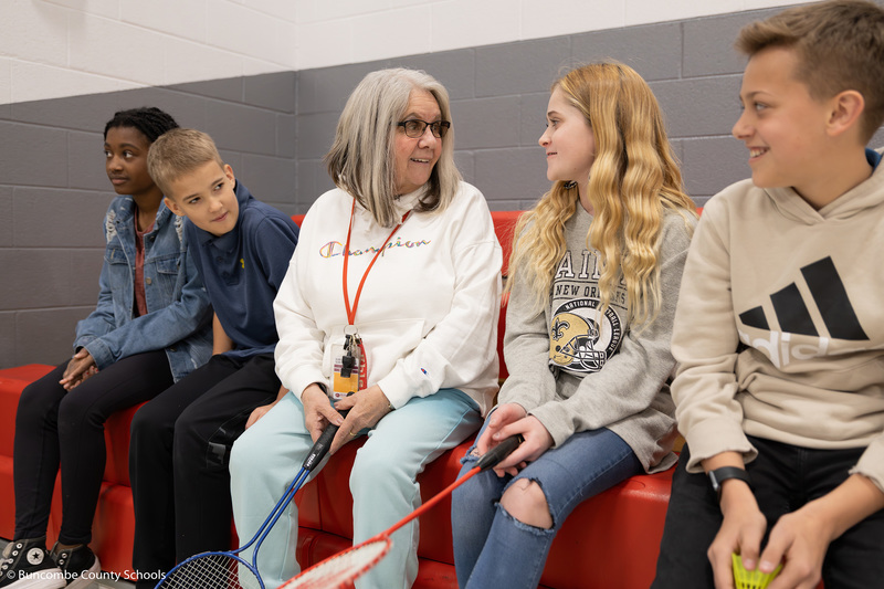 Mrs. Jennings talking to a group of students during PE. 